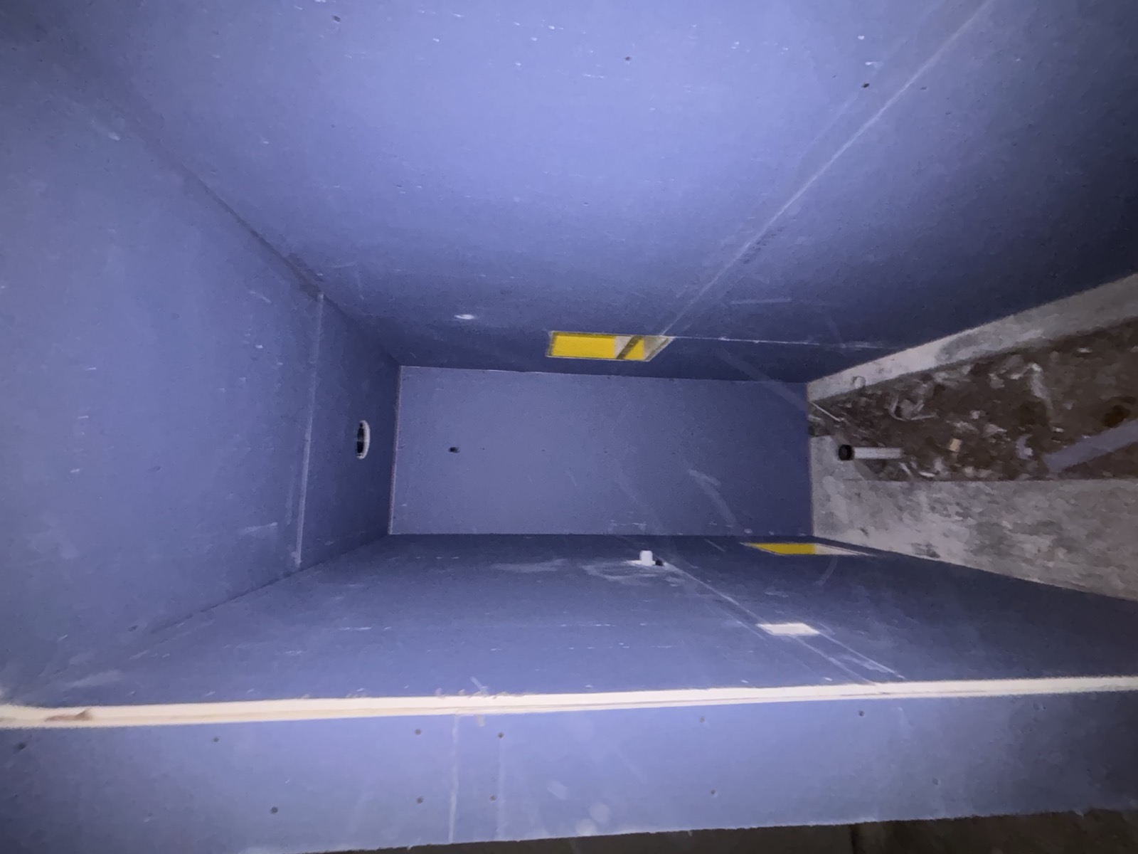 Before: basement with drywall hung, seams not yet finished